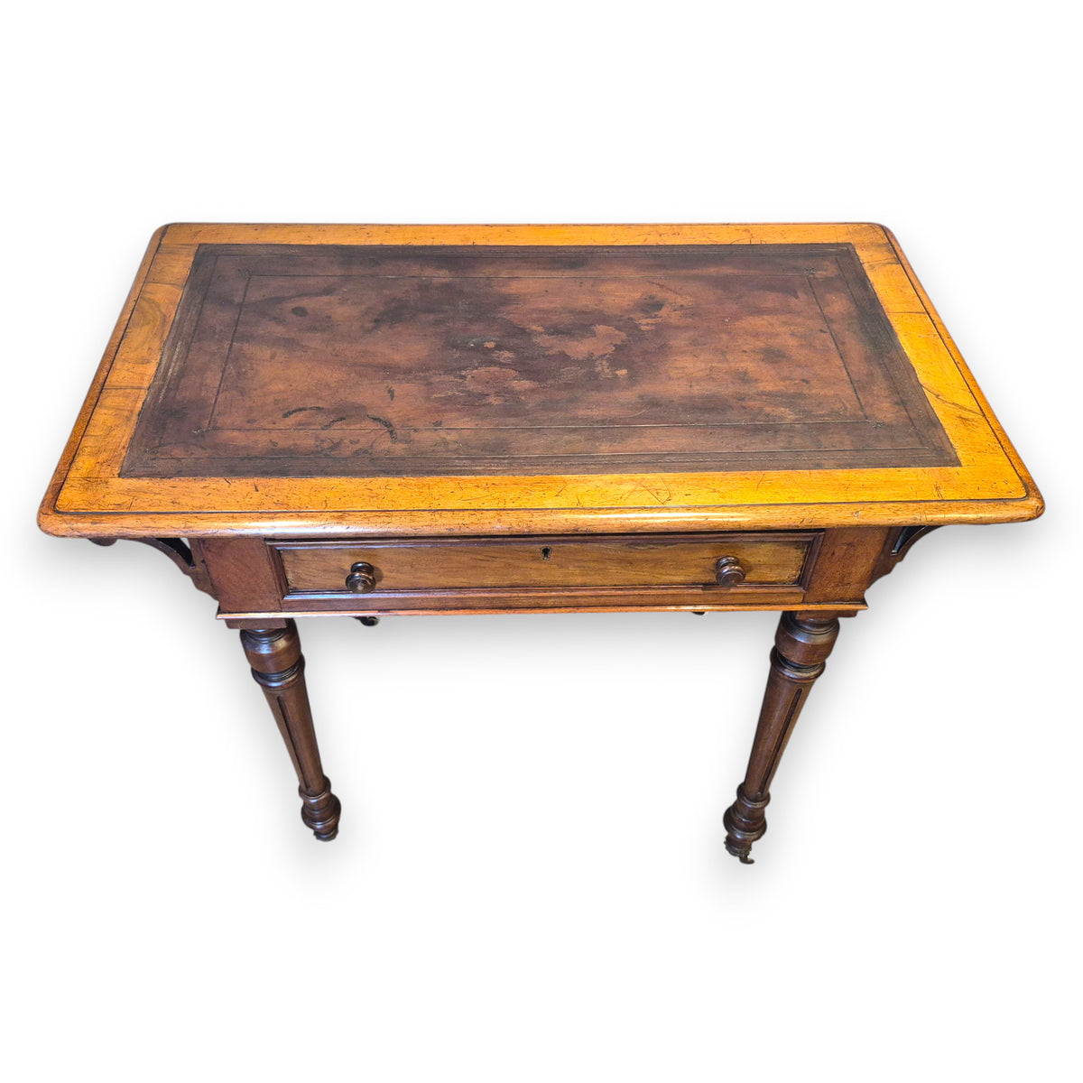 Front view of Victorian walnut writing desk with single drawer and turned legs