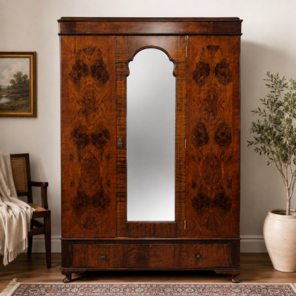 Art Deco burr walnut mirrored wardrobe staged in an elegant bedroom interior