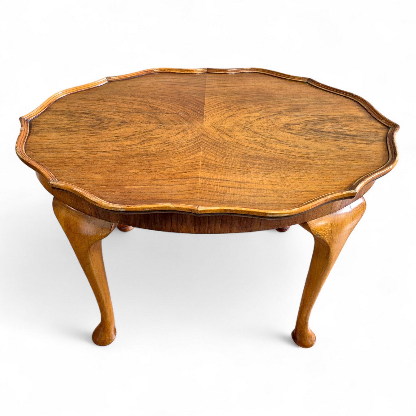 Close-up of burr walnut grain and scalloped tabletop detailing