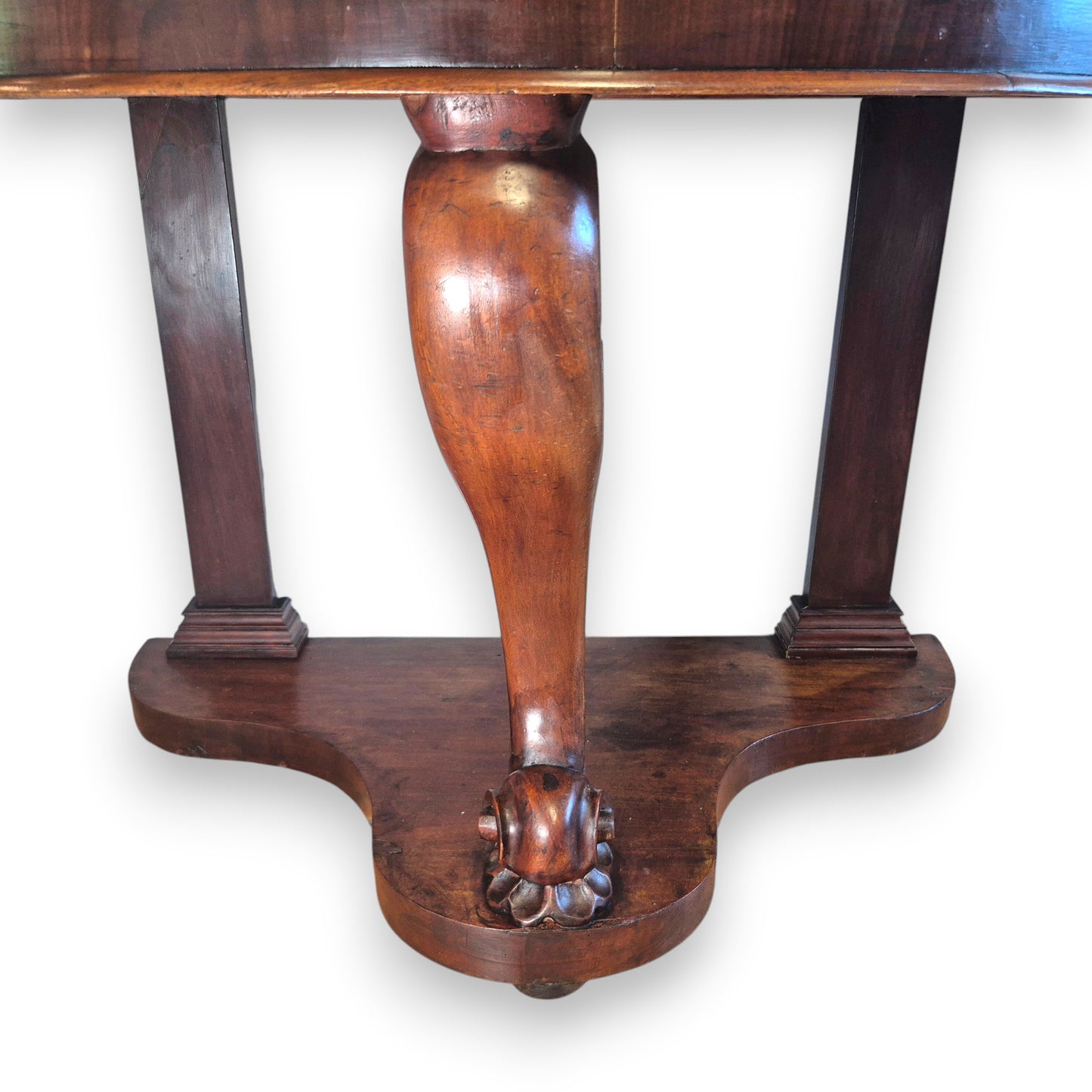 Late 19th-century mahogany washstand with a marble top, curved front and decorative carved base.