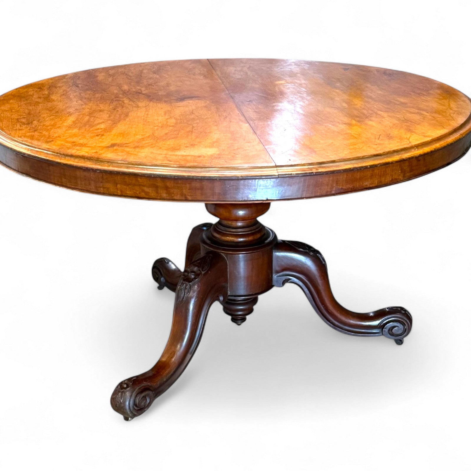 Detailed view of carved pedestal and cabriole legs on antique Victorian mahogany table