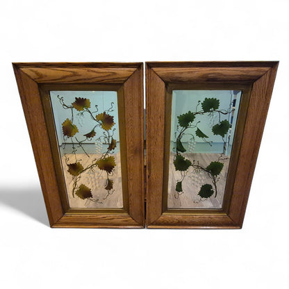 Pair of antique Victorian reverse painted mirrors with solid oak frames, featuring vine and leaf motifs and late 19th-century craftsmanship – elegant decorative wall mirrors by Avego Antiques.