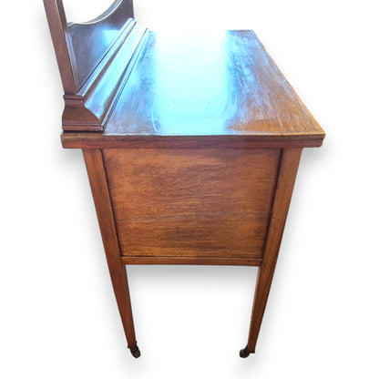 Side view of antique mahogany veneer dressing table with raised oval mirror