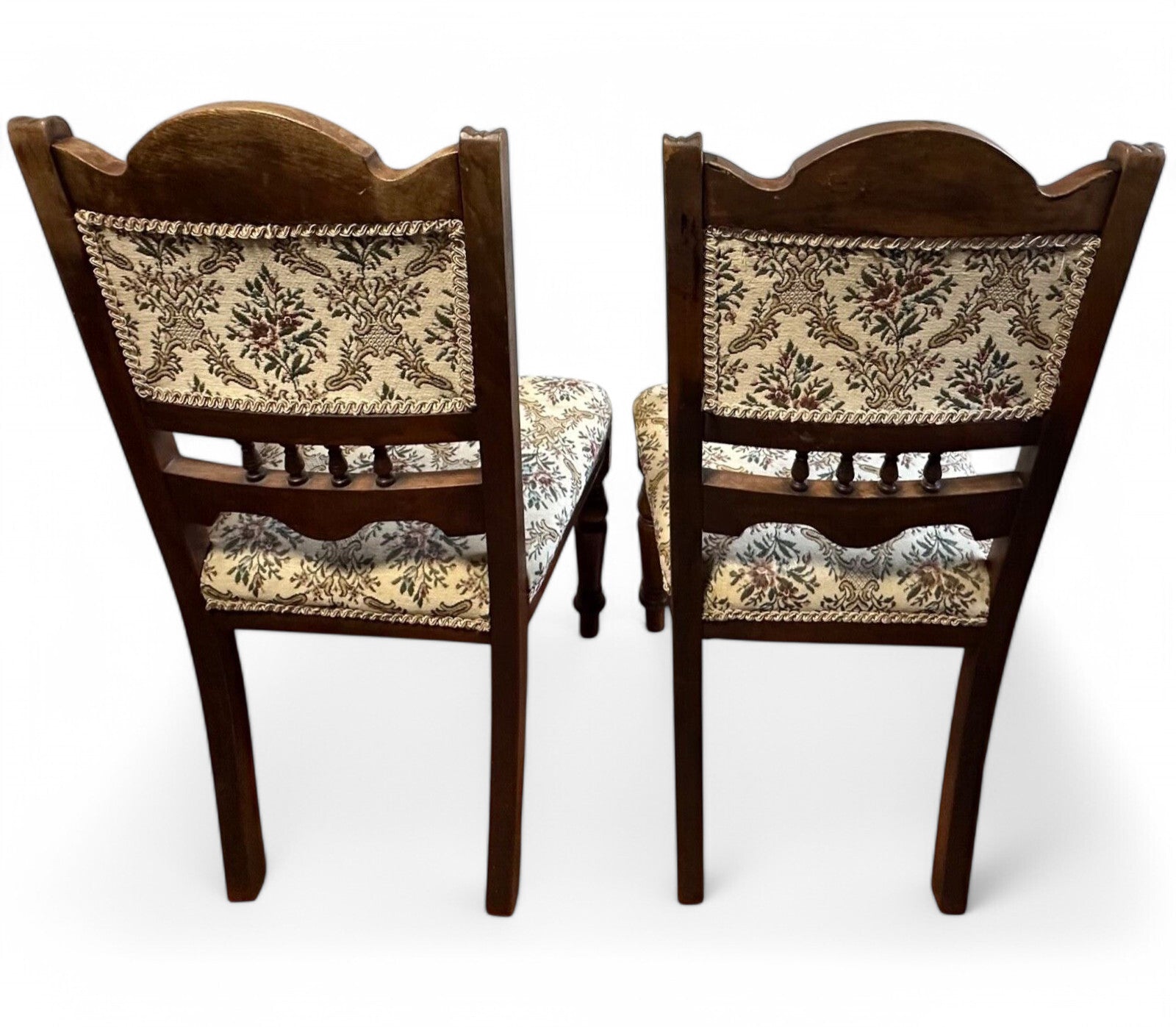 Rear view of Edwardian mahogany low chairs with traditional frame design and smooth aged finish.