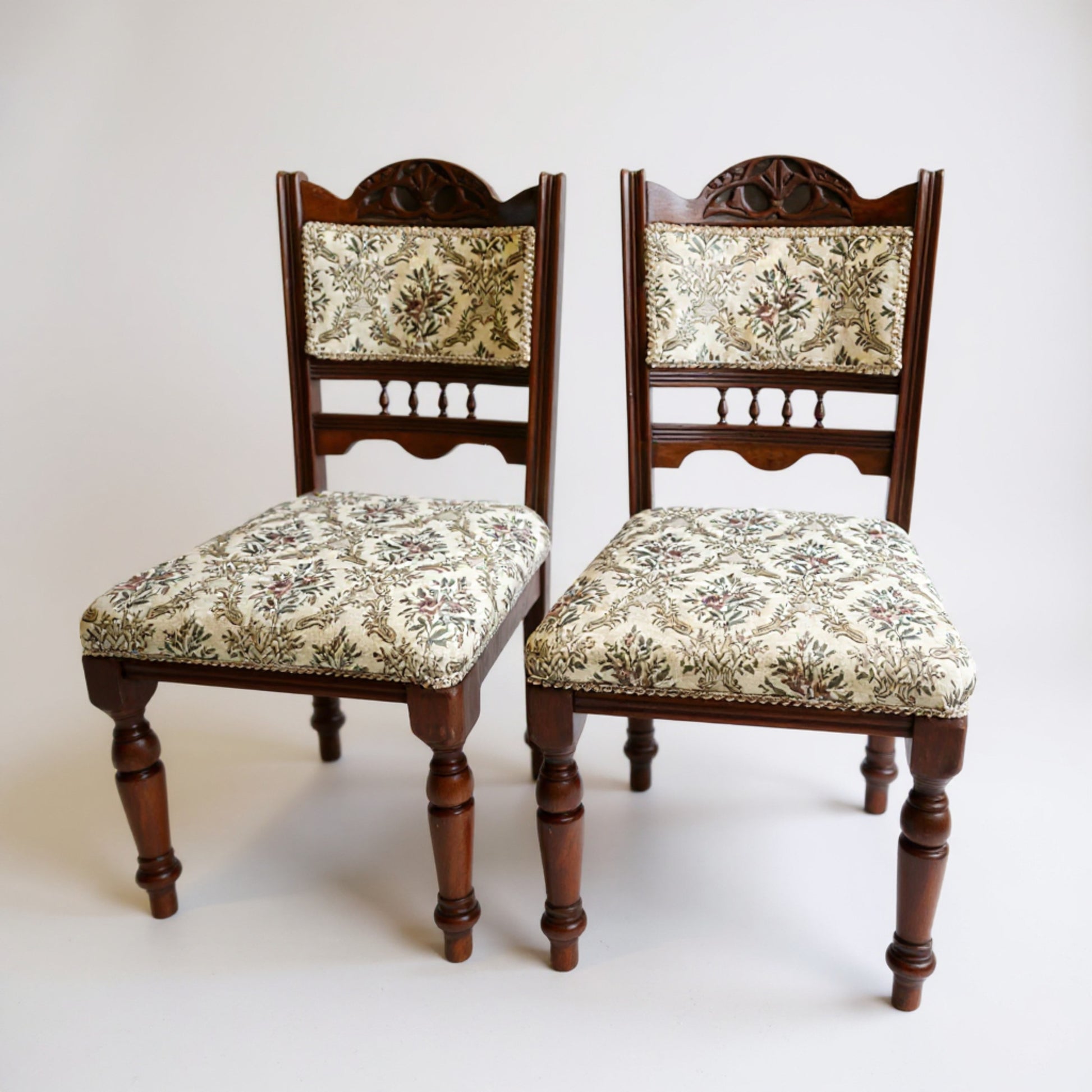 Pair of Edwardian hardwood low chairs with cream upholstery and mahogany frames — antique dining or hall seating from Avego Antiques.
