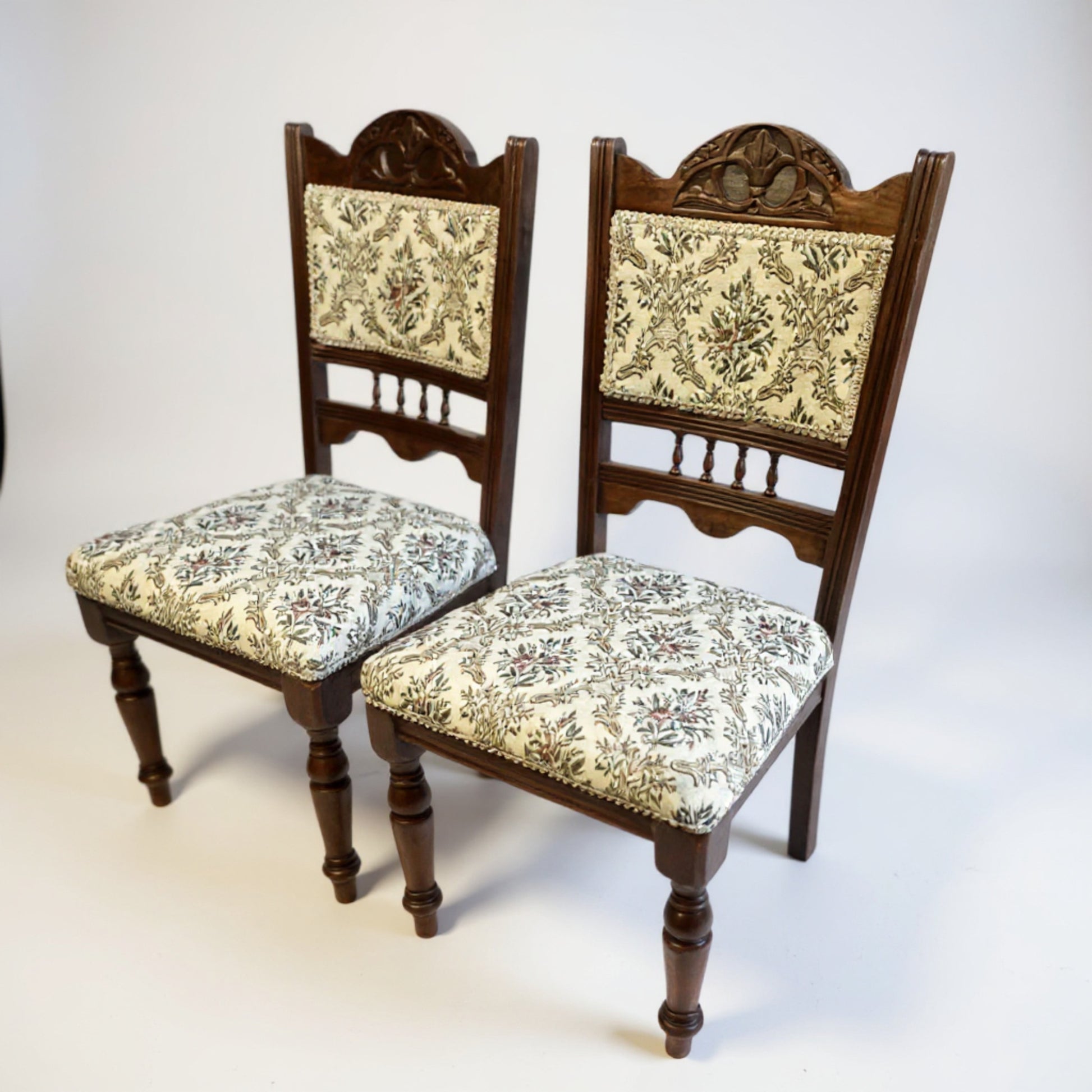 Edwardian mahogany low chairs showing elegant lines, rich patina, and turned legs — classic early 20th-century craftsmanship.