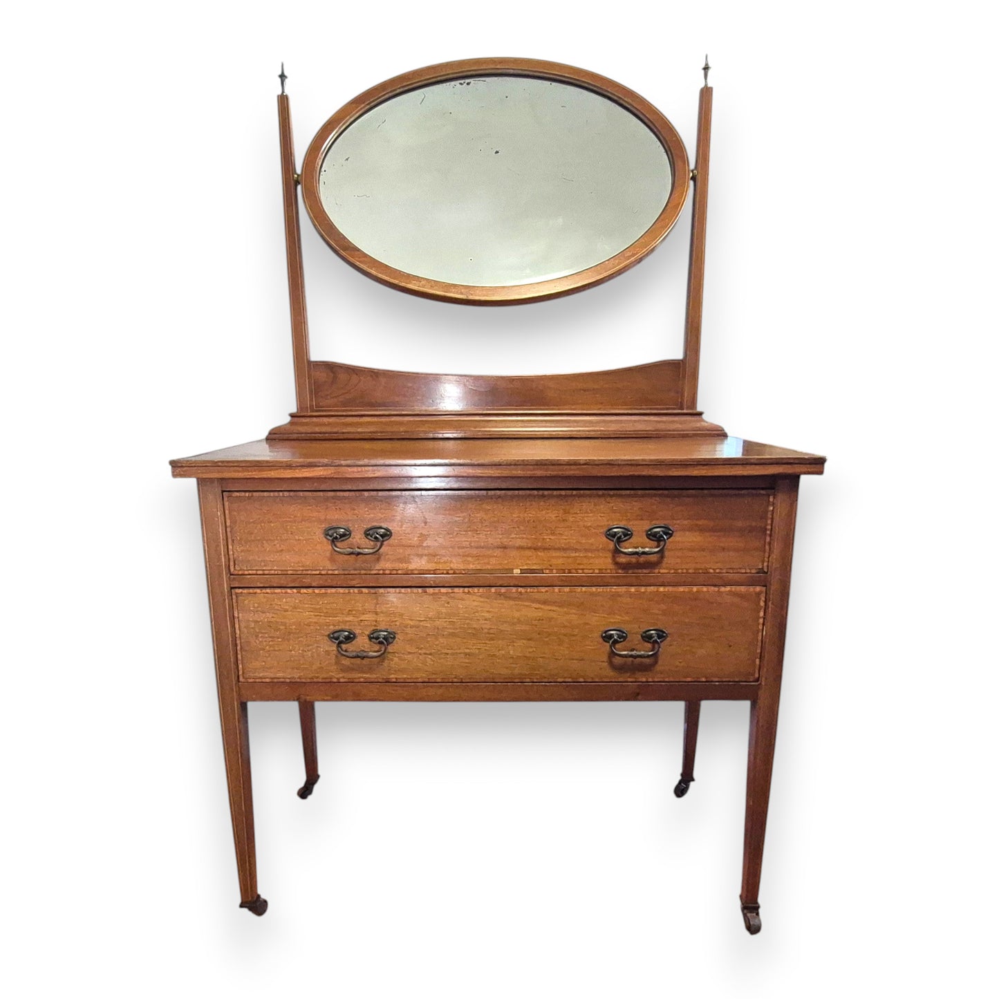 Edwardian bedroom vanity with warm mahogany patina and aged foxed mirror