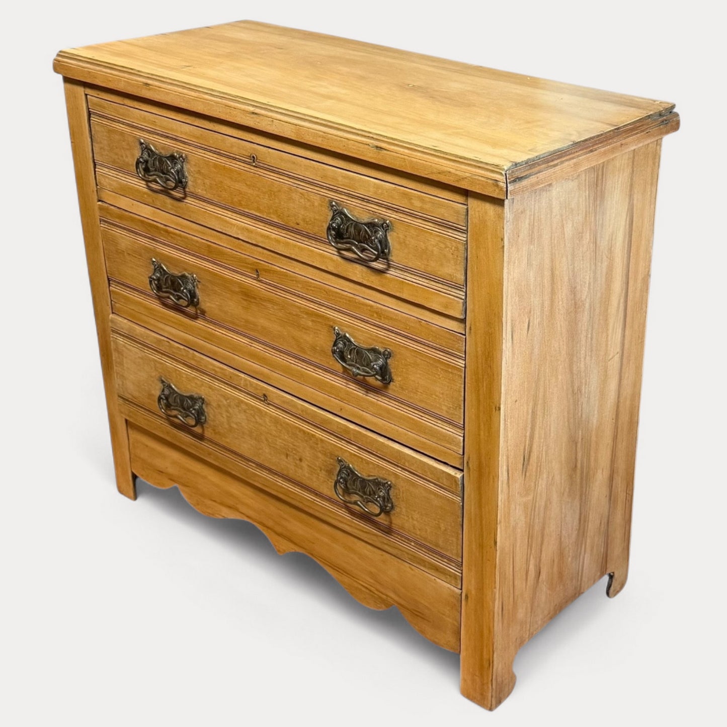 Front view of Edwardian pine chest showing three drawers and bracket feet