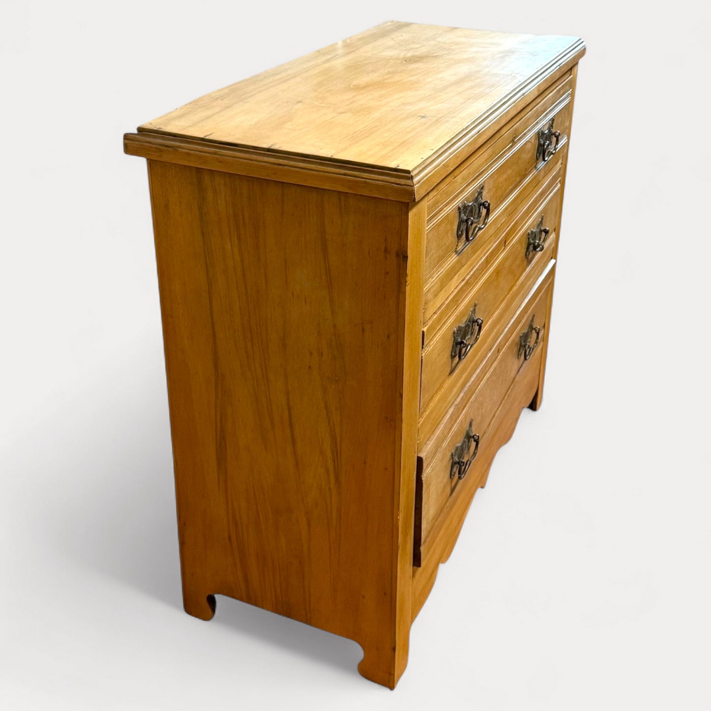 Side view of Edwardian pine chest showing three drawers and bracket feet