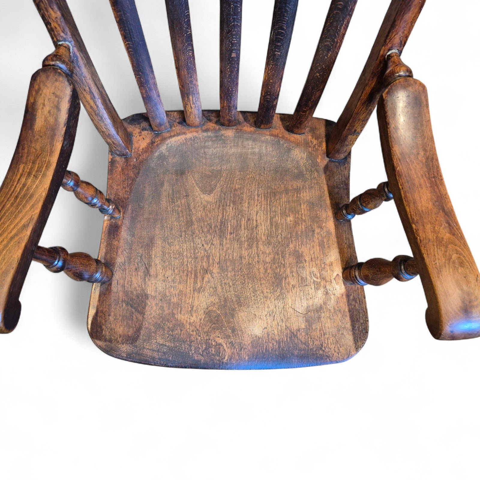 Close-up of elm seat showing beautiful grain and aged patina on antique Windsor chair