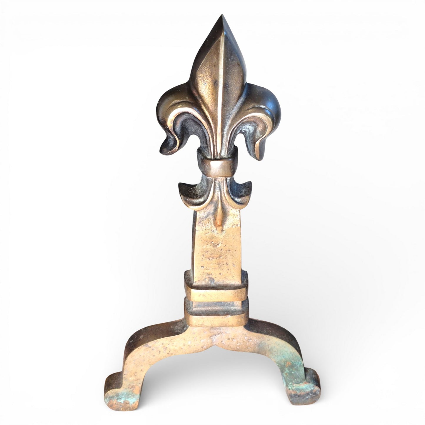 Detail of brass fleur-de-lis finial on antique fire grate