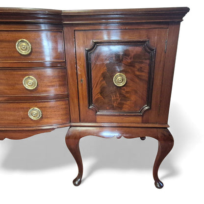 Close-up of flame-mahogany door panels on antique sideboard