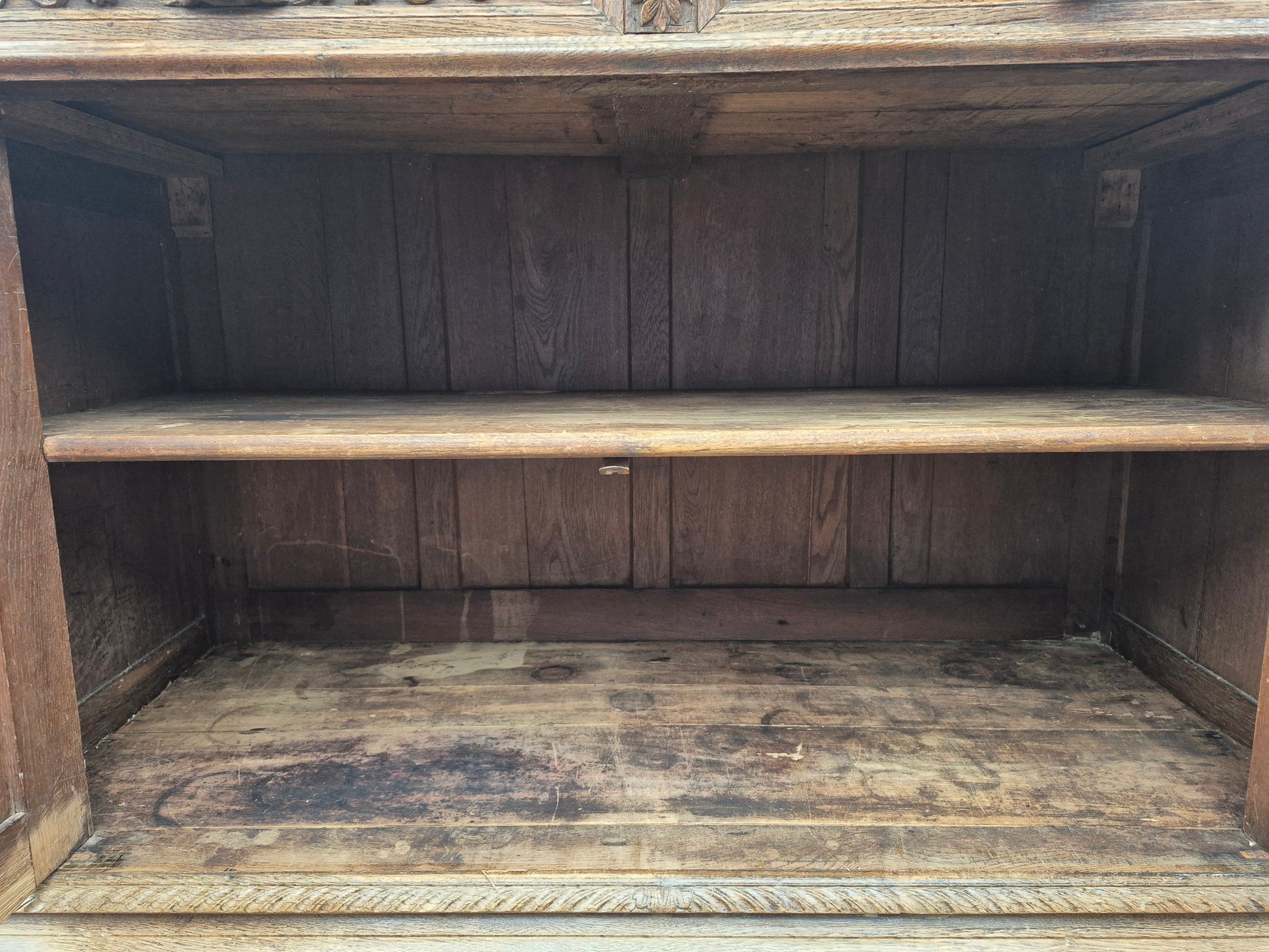 Lower cabinet with floral and scroll carvings on antique French oak dresser
