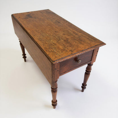 Front view of antique Georgian mahogany console table with drawer and drop leaf