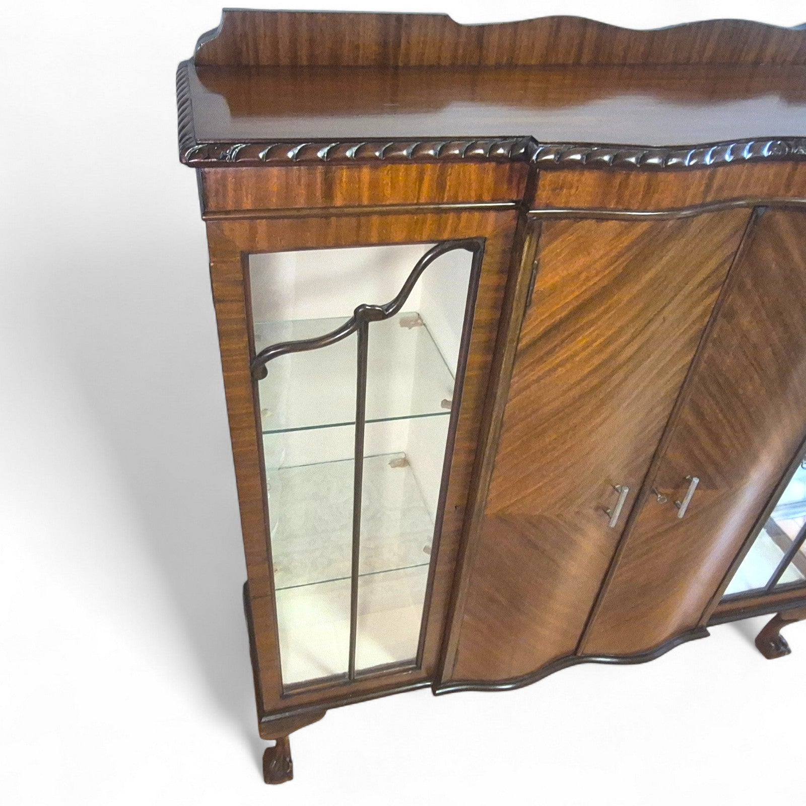 Interior shelves of display cabinet with glass panels and mahogany finish
