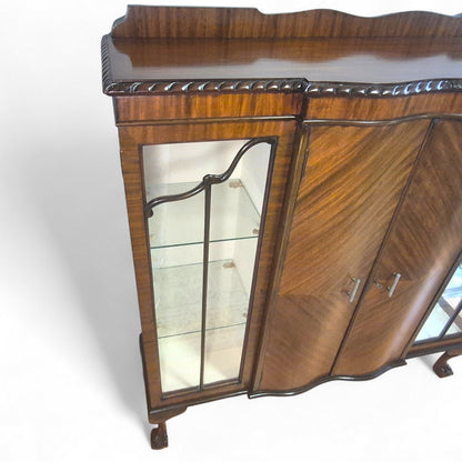 Interior shelves of display cabinet with glass panels and mahogany finish