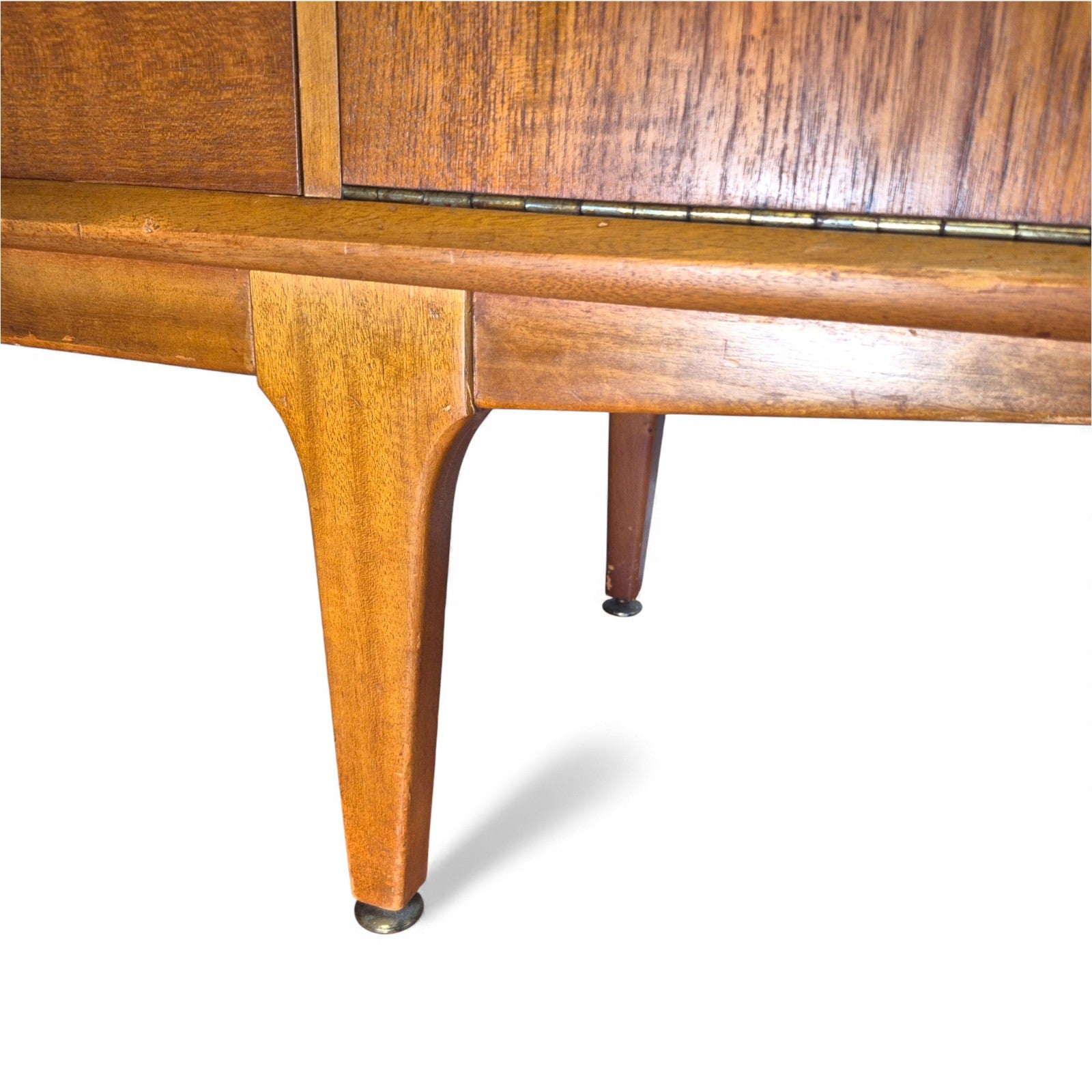 Close-up of Jentique sculpted teak legs on mid-century sideboard