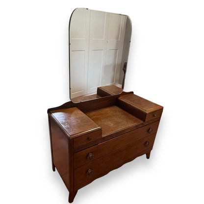Front view of mid-century oak dressing table with drawers and mirror