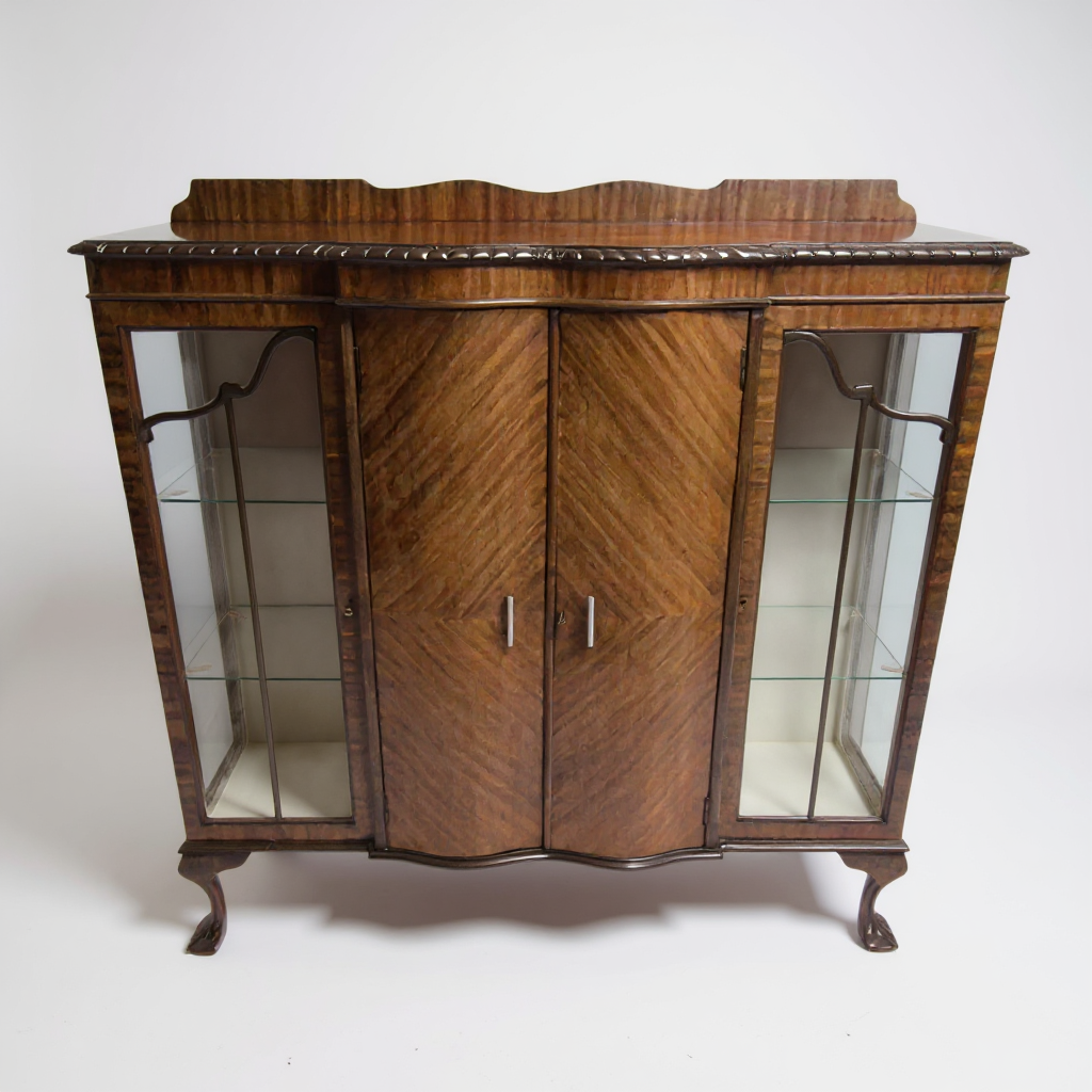 Antique mahogany display cabinet with glass-panelled doors and carved cornice