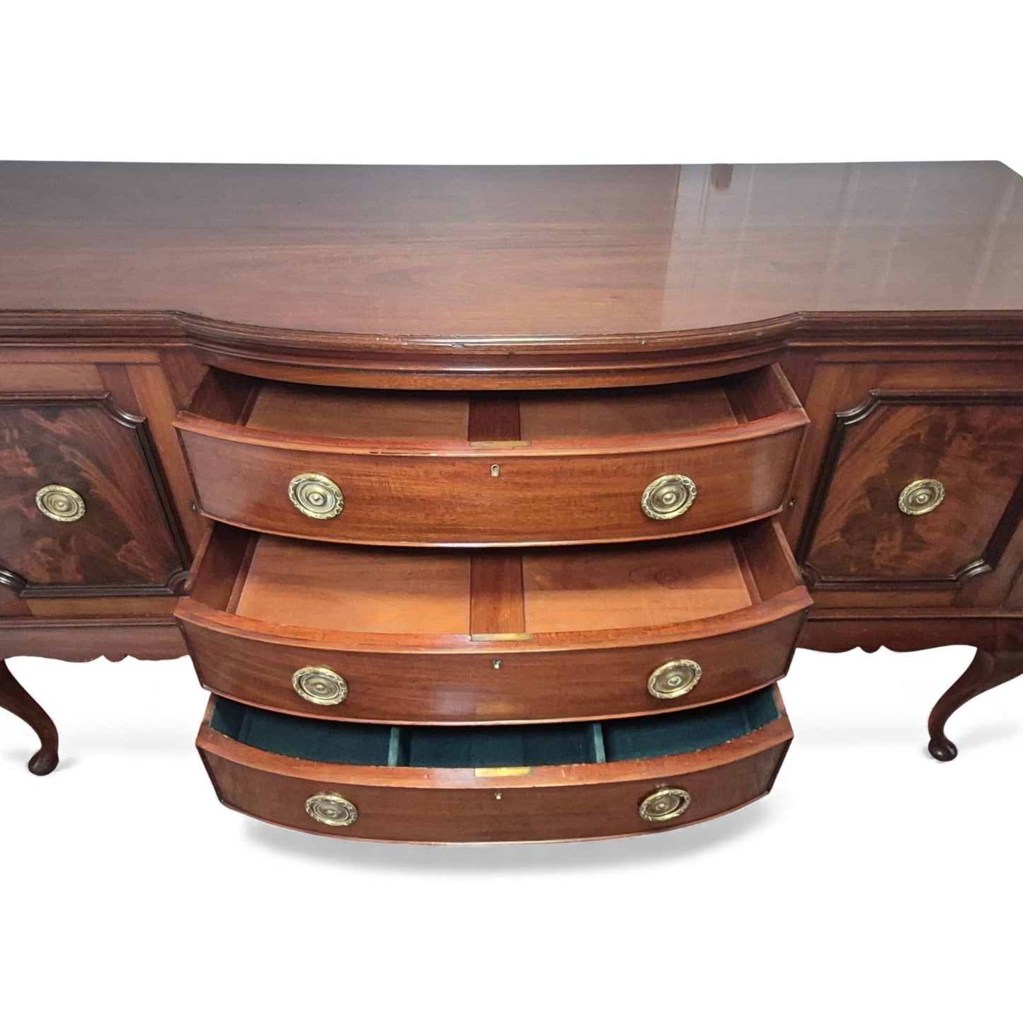 Close-up of brass roundel handles on mahogany drawers