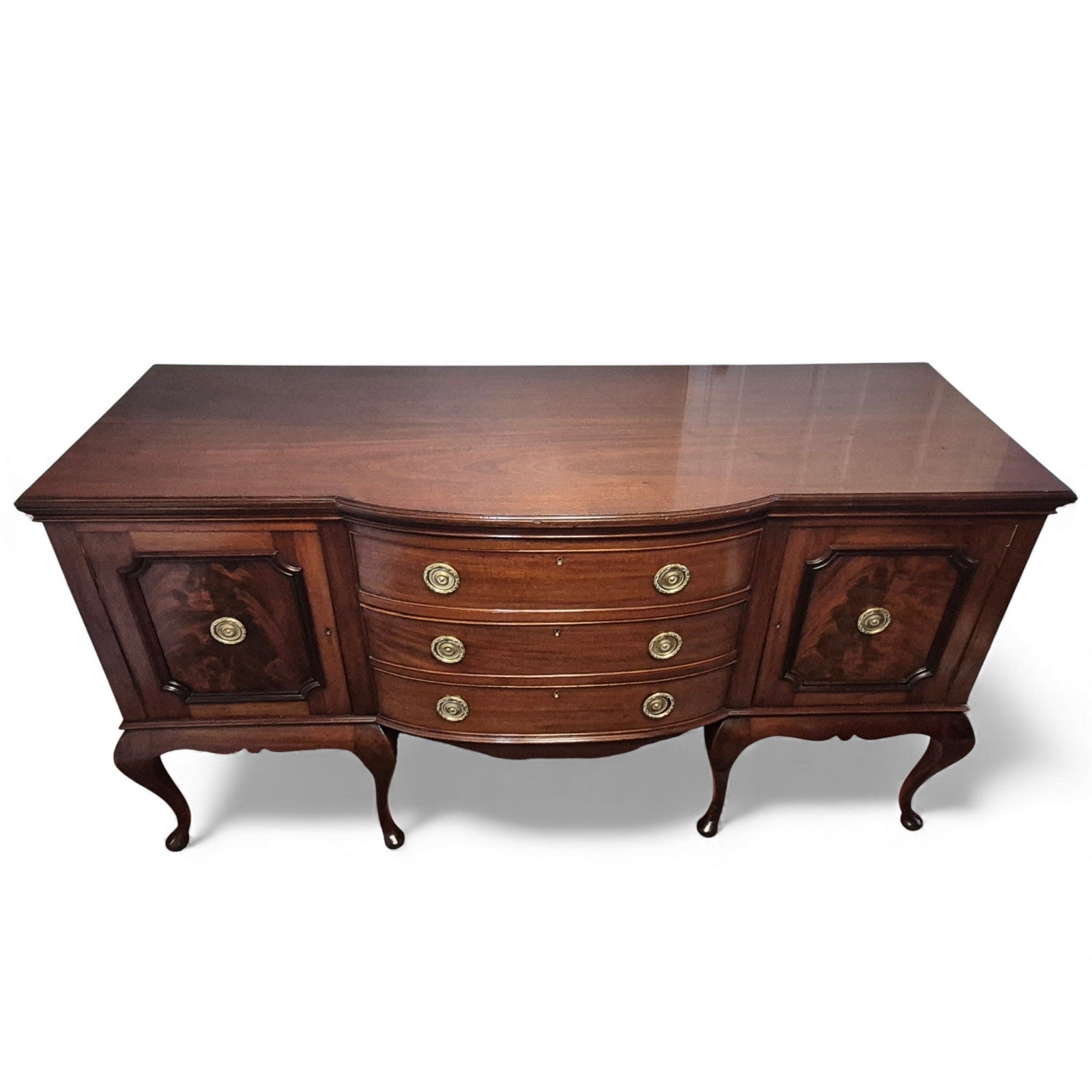Front view of mahogany sideboard with cupboards and three central drawers