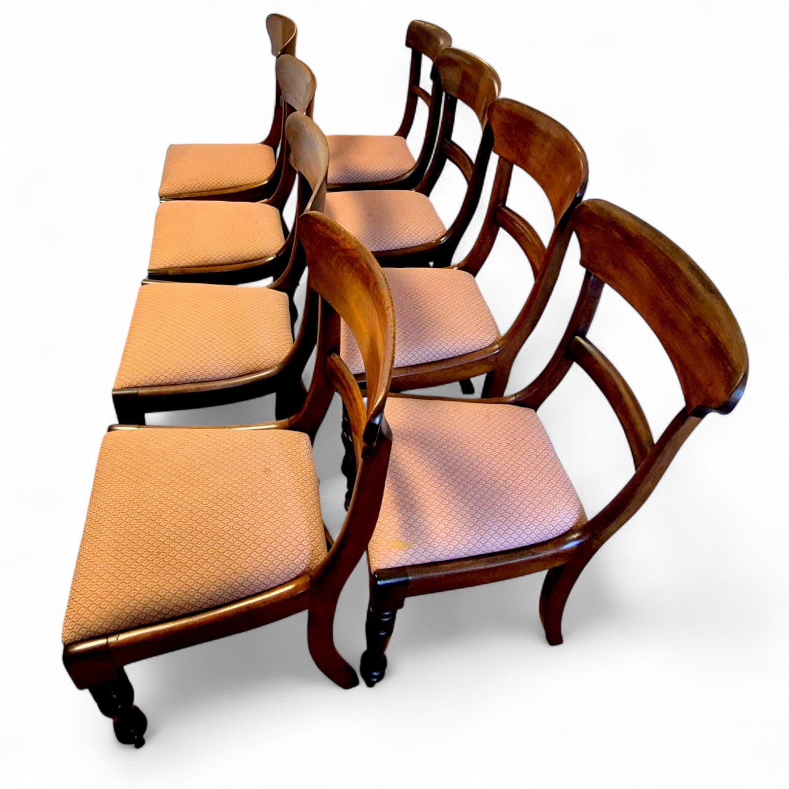 Side view of antique mahogany dining chairs with reupholstered seats (2022)