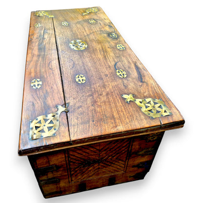 Top view of antique padouk blanket box with decorative brass fittings