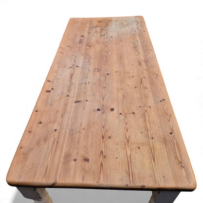 Traditional pine dining table showing plank top grain and natural patina