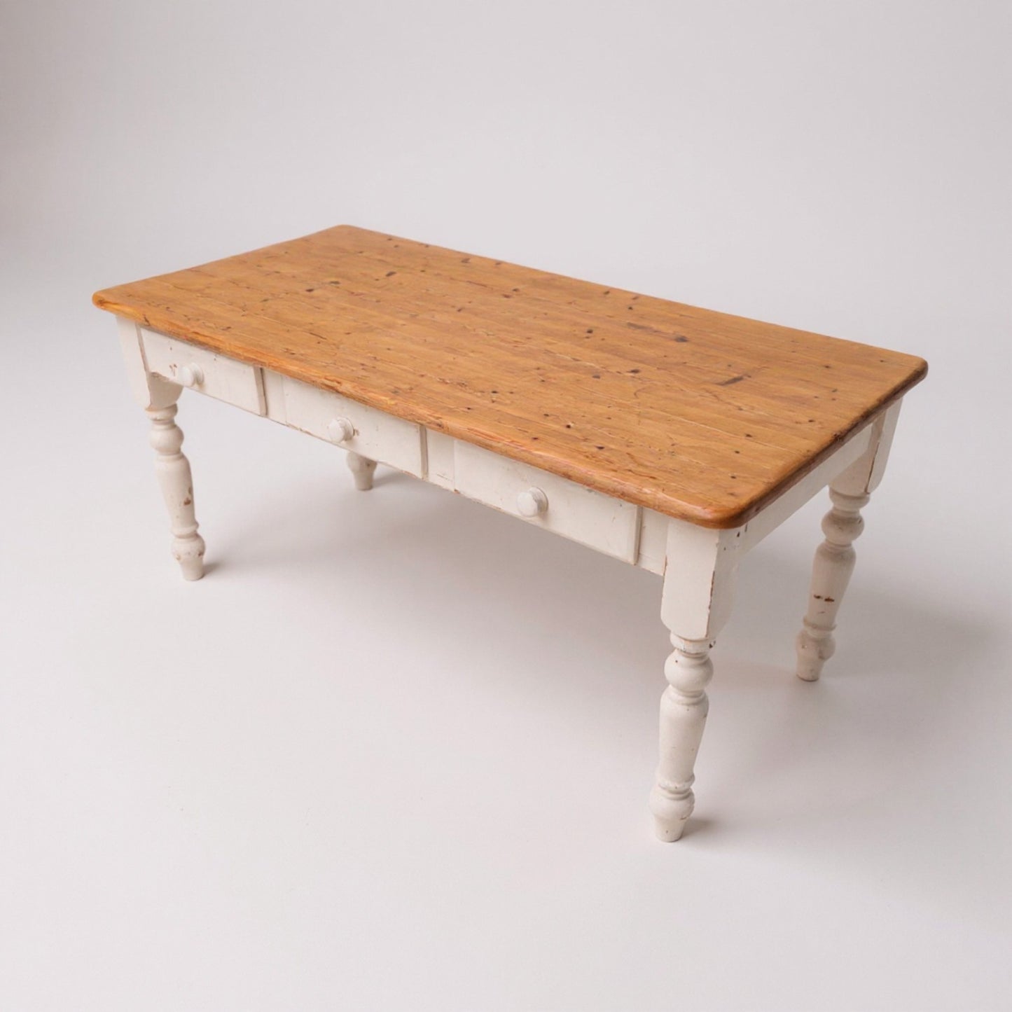 Pine farmhouse kitchen table with aged plank top and painted base