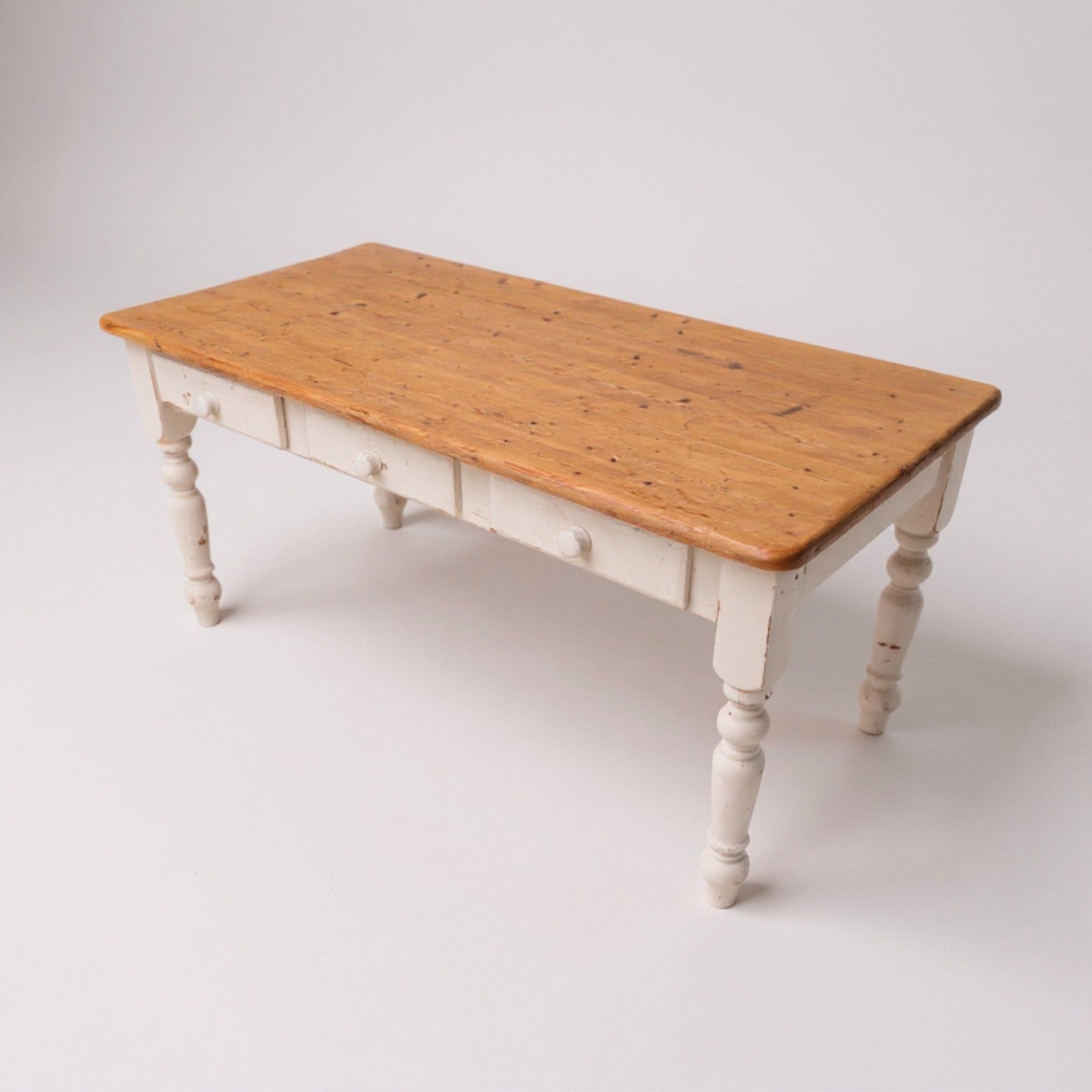 Pine farmhouse kitchen table with aged plank top and painted base