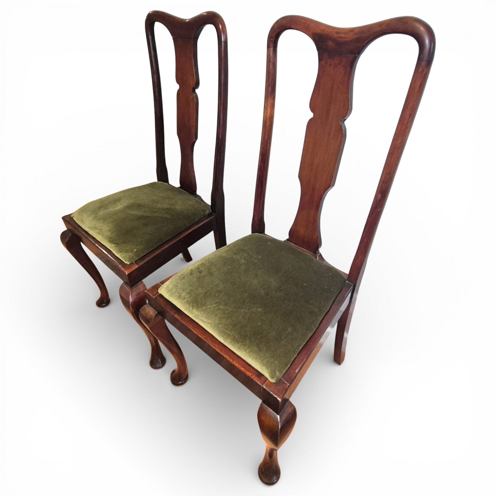 Queen Anne style mahogany dining chairs showing high backs and cabriole legs