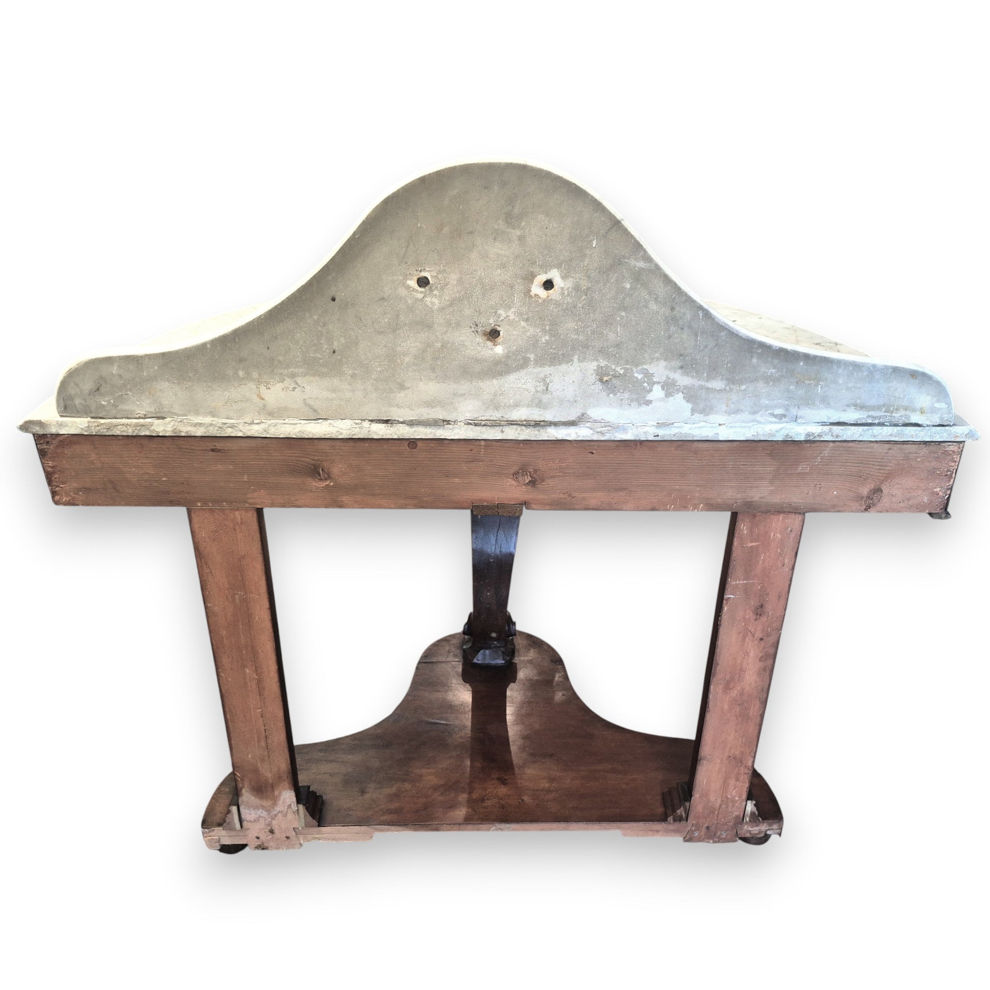 Rear view of a Victorian mahogany washstand featuring a curved marble top and carved central support.