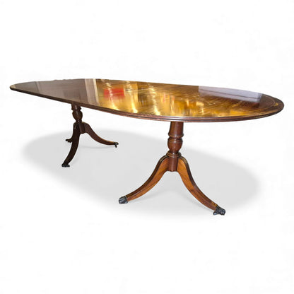 Twin pedestal bases with splayed legs, brass feet and castors