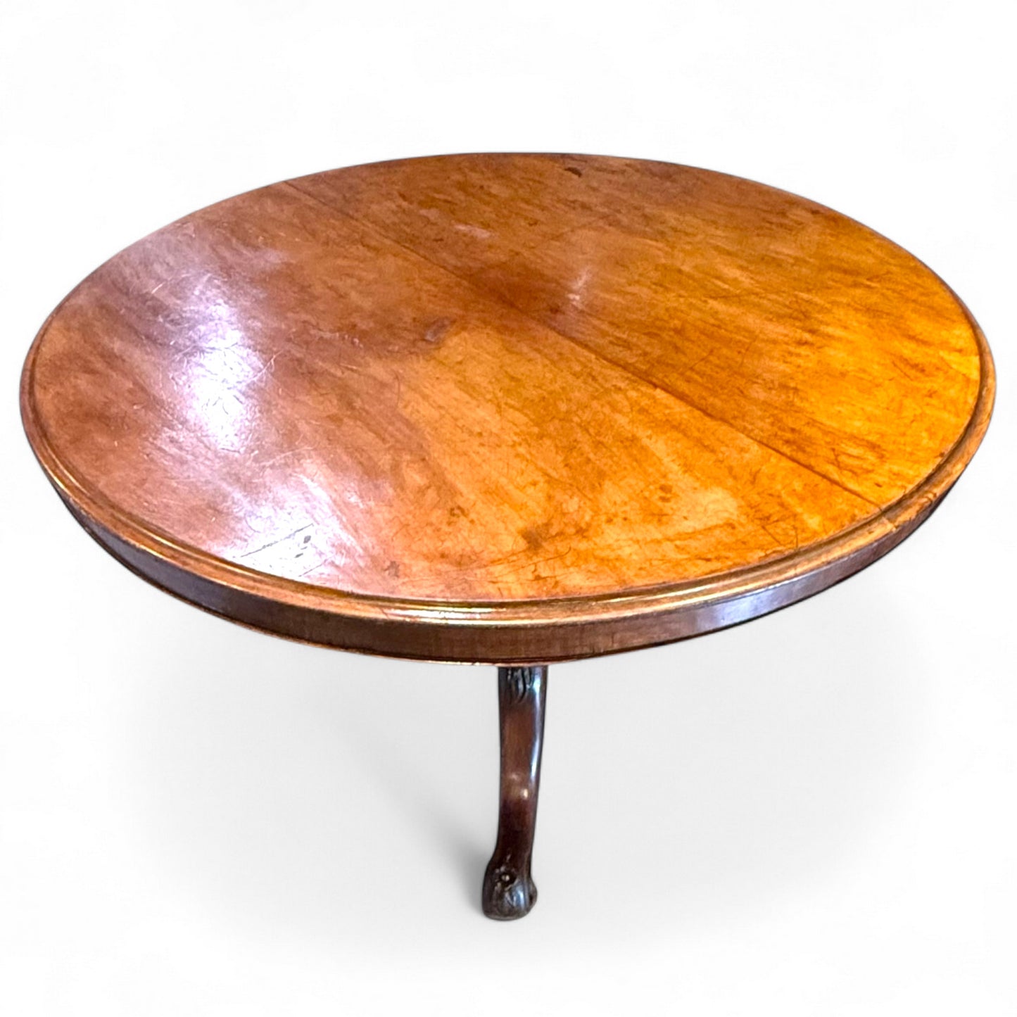 Wooden round table with a single leg on a white background