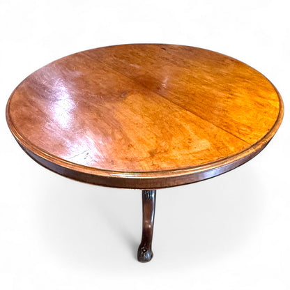 Wooden round table with a single leg on a white background