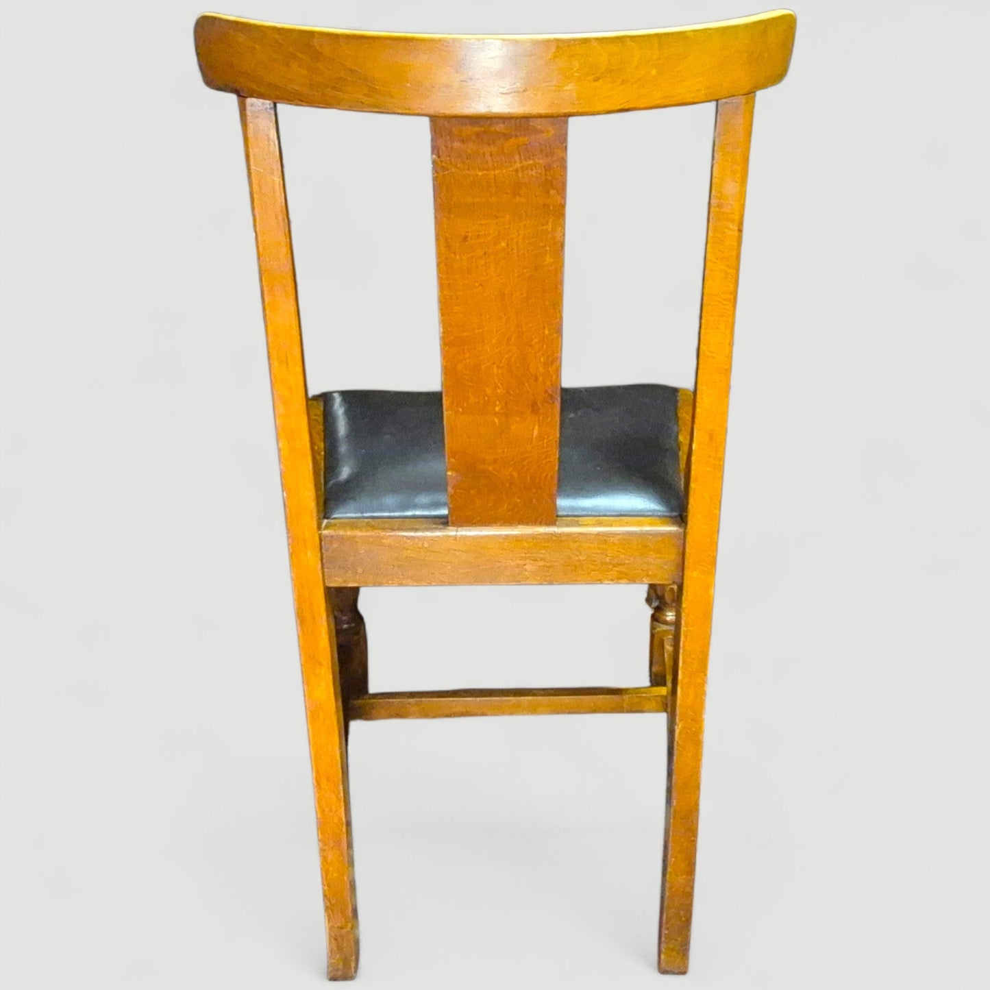 Back view showing craftsmanship and grain of 1920s oak dining chairs
