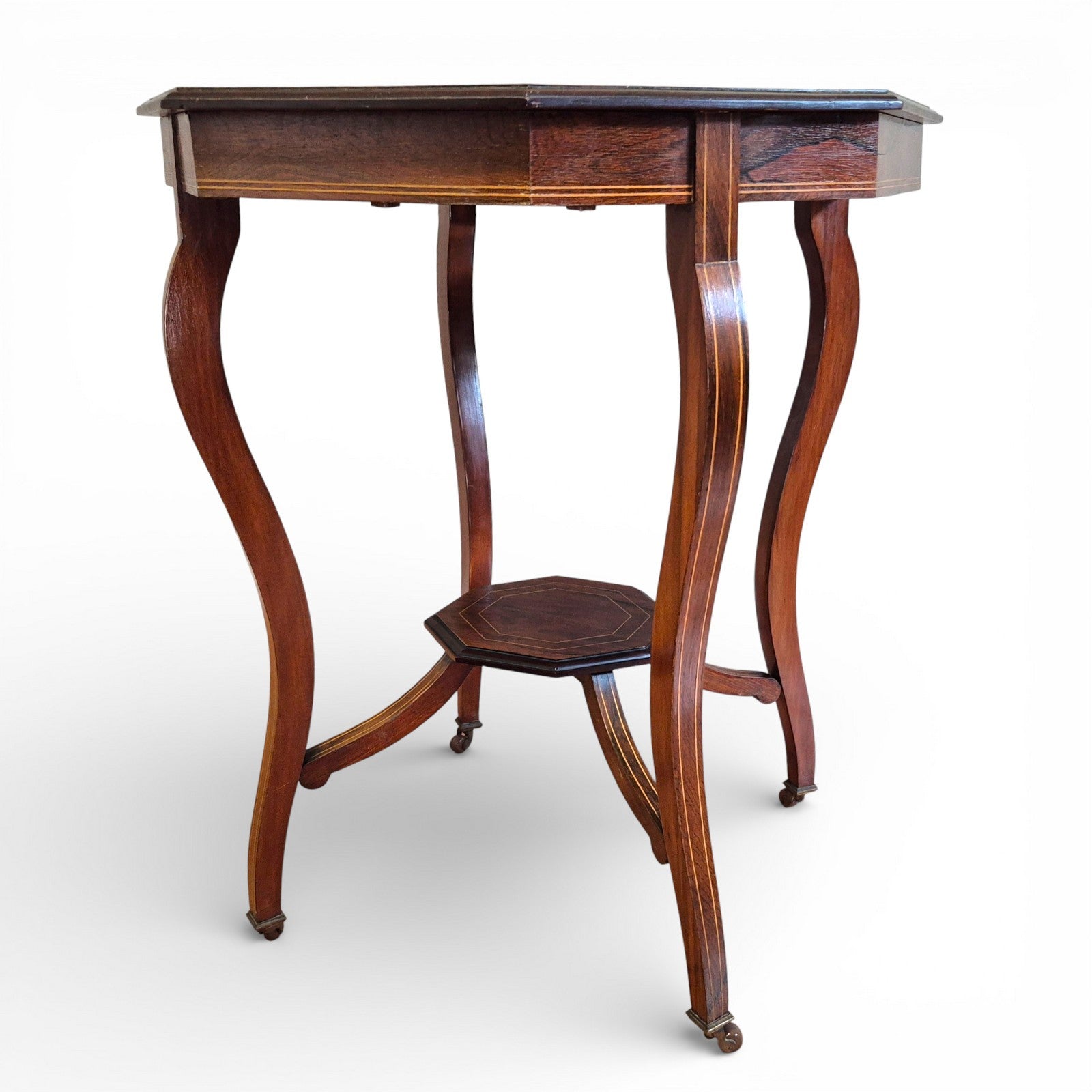 Side profile showing the Victorian Rosewood Tables cabriole legs with original castors