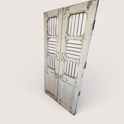 Tall indian jali timber doors with stainless steel bars