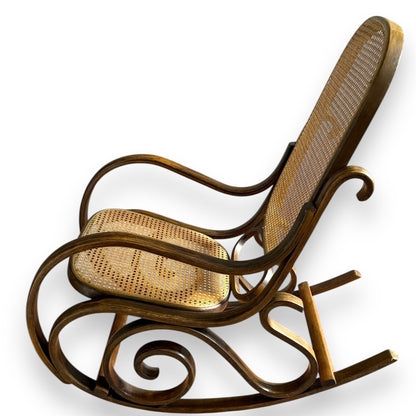 Antique bentwood rocking chair – side profile showing elegant shape and cane work