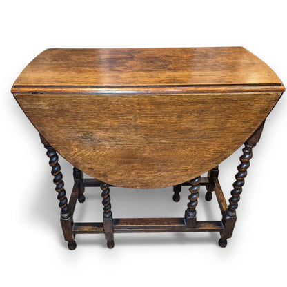 Folded Victorian gate-leg table showing compact storage size