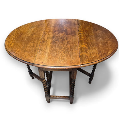 Victorian gate-leg table shown open with oval top and aged patina