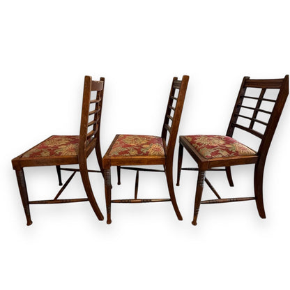 Side profile of antique Victorian ladderback chair with turned front legs and padded seat