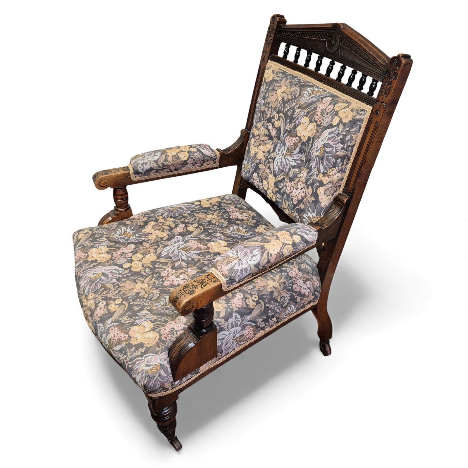 Antique Victorian oak nursing chair with carved crest rail and floral upholstery