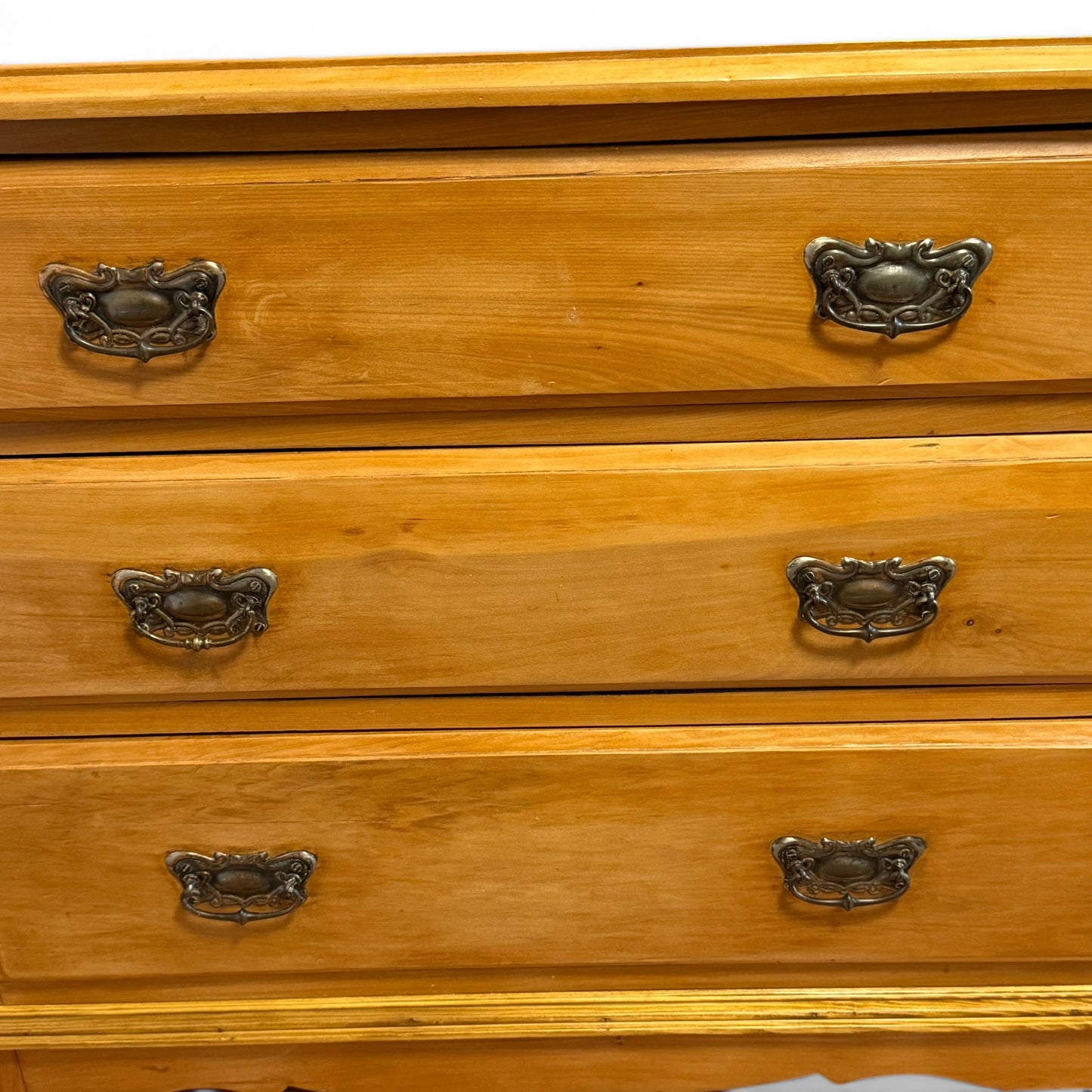 Detail of Victorian pine chest drawer fronts and handles