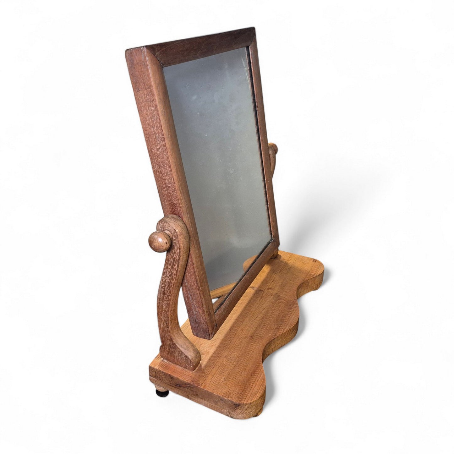 Tabletop pine swing mirror showing aged patina and curved base