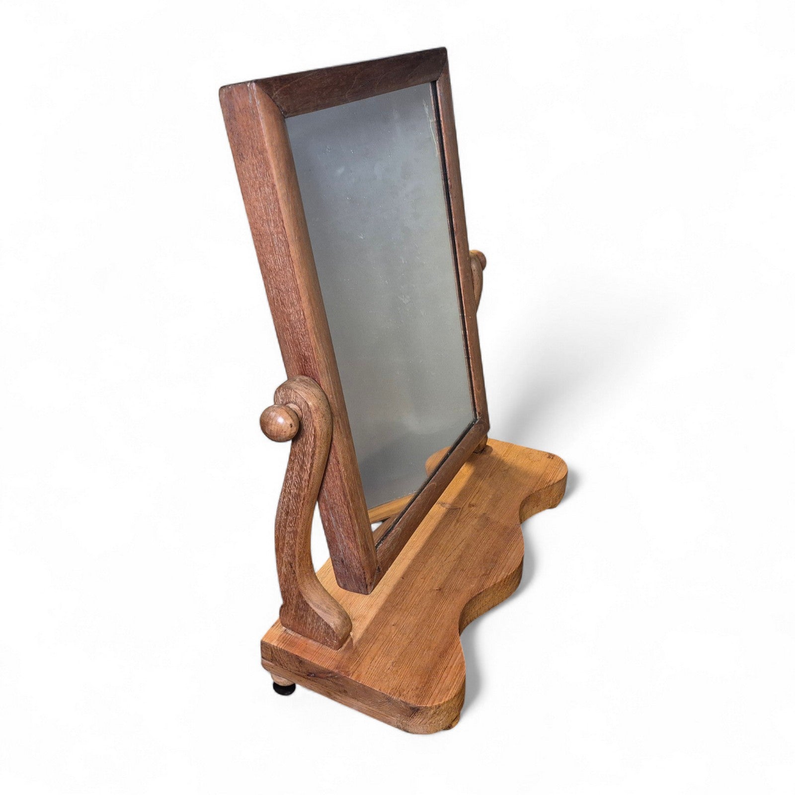 Tabletop pine swing mirror showing aged patina and curved base