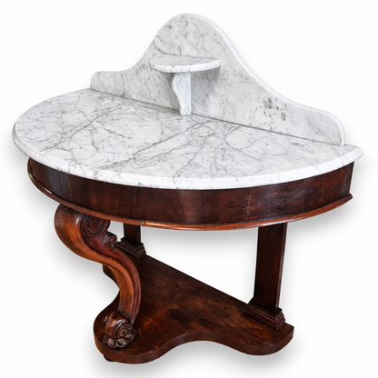 Antique demi-lune mahogany console table with grey-veined marble top and decorative platform base.
