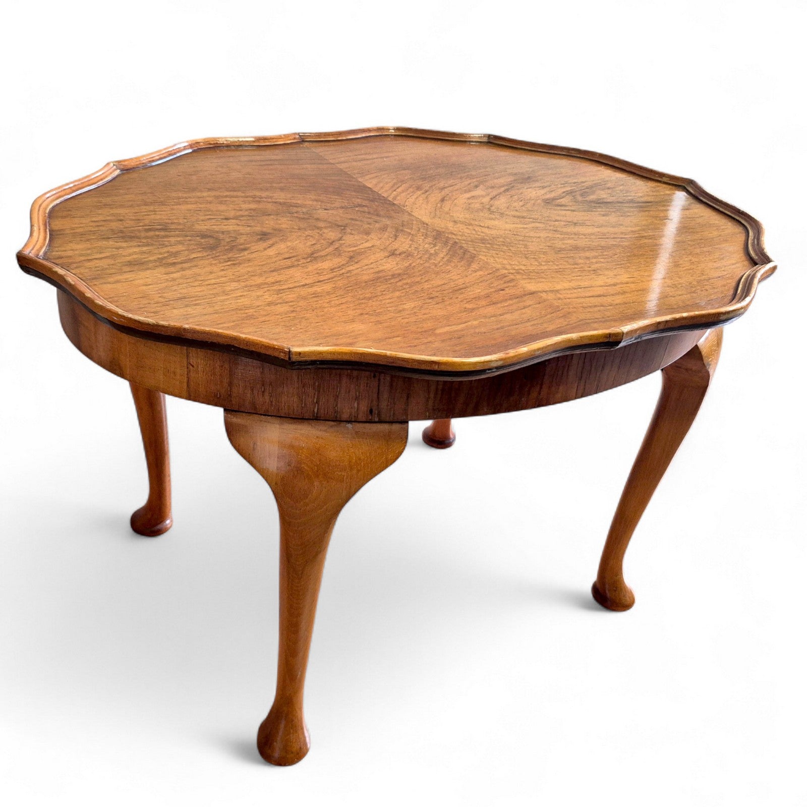 Side view of vintage walnut coffee table showing cabriole legs