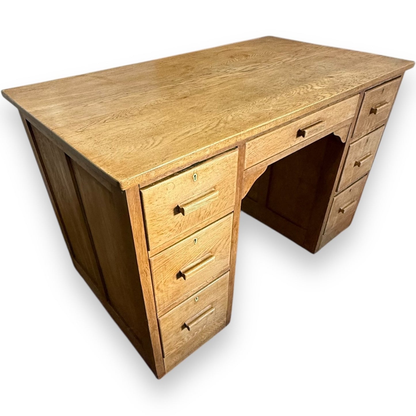 Left view of Art Deco oak desk showing pedestal drawers and smooth patina – early 20th century design