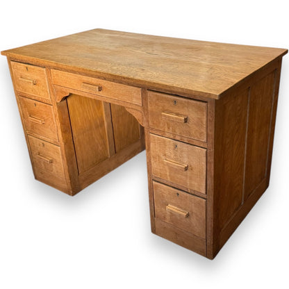 Art Deco oak desk showing pedestal drawers and smooth patina – early 20th century design